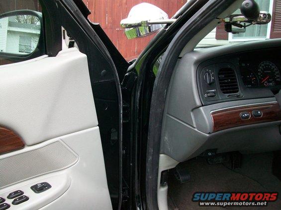 2003 Ford Crown Victoria interior showing door panel, dashboard, and steering wheel