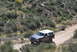 1996 Ford Bronco - This 1996 Ford Bronco navigates a dusty trail surrounded by arid vegetation.