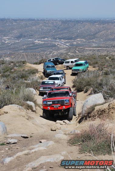 Red Ford Bronco with winch on rocky trail, front view
