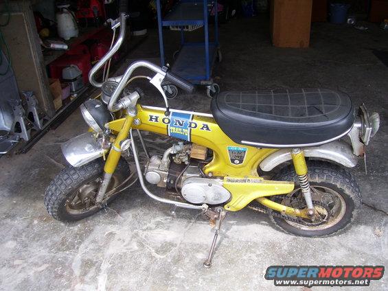 Yellow 1970 Honda CT70 Trail motorcycle with black seat and chrome handlebars