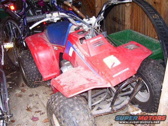 Red ATV with blue seat and "HONDA 70" markings