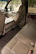 2003 Ford F-350 - The interior of a truck is shown, tan leather seats and a view of trees through the windows.