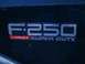 2003 Ford F-350 - Close-up of a Ford F-250 Lariat Super Duty badge on a vehicle.