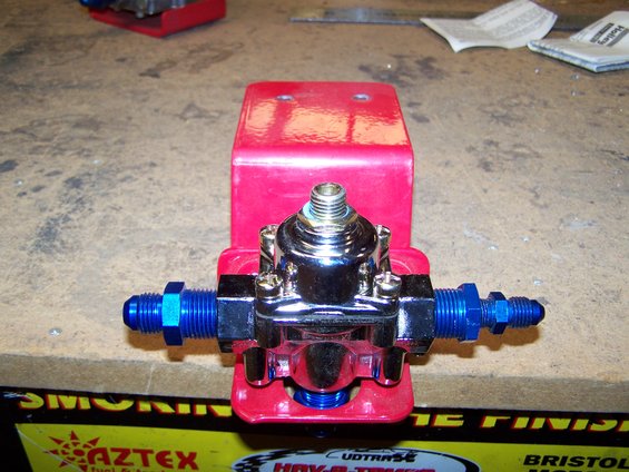 050.jpg I'm planning on mounting my pump on the crossmember in front of the gas tank. Then my plan is: 

hose from tank to "in" on pump

out of pump to "in" on filter, mounted on driver side frame rail

out of filter to "in" on regulator, mounted on bottom of cowl, beside M/C

1 hose out of reg. to carb inlet, which will be at the rear of carb

1 hose,4AN, out of reg. to the gauge, mounted on cowl, in front of driver



