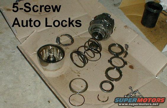 b35.jpg 5-screw Lock Disassembled
This level of disassembly is NOT necessary for removal or replacement.
4-slot spanner nut - E5TZ1197A 
4-tab lock washer - E5TZ1198A

This early axle uses a single thick steel splined thrust washer (closest to the cap screws) instead of the later 3-piece thrust washer.  Install three washers in order: metal washer first, plastic washer second and splined washer last.

[url=http://www.supermotors.net/registry/media/1053962][img]http://www.supermotors.net/getfile/1053962/thumbnail/autolock5brkdn.jpg[/img][/url] . [url=http://www.supermotors.net/registry/media/895156][img]http://www.supermotors.net/getfile/895156/thumbnail/hublock5scrx.jpg[/img][/url] . [url=http://www.supermotors.net/registry/media/170464][img]http://www.supermotors.net/getfile/170464/thumbnail/autolock5screw.jpg[/img][/url] . [url=http://www.supermotors.net/registry/media/757655][img]http://www.supermotors.net/getfile/757655/thumbnail/autolock8593.jpg[/img][/url] . [url=http://www.supermotors.net/registry/media/479613][img]http://www.supermotors.net/getfile/479613/thumbnail/autolock5parts.jpg[/img][/url] . [url=http://www.supermotors.net/registry/media/470241][img]http://www.supermotors.net/getfile/470241/thumbnail/autohublocksop.jpg[/img][/url] . [url=http://www.supermotors.net/registry/media/470473][img]http://www.supermotors.net/getfile/470473/thumbnail/tsb970628motoringtorque.jpg[/img][/url] . [url=http://www.supermotors.net/registry/media/701808][img]http://www.supermotors.net/getfile/701808/thumbnail/spanners.jpg[/img][/url]