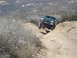 1986 Ford Bronco - This SUV navigates a challenging off-road path with steep inclines and rocky terrain.