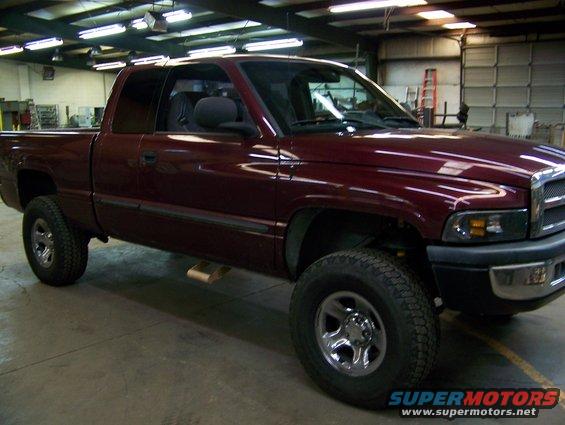 Maroon 2001 Dodge 1500 pickup truck parked inside a garage