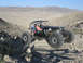 1970 Mercury Cougar - A custom-built off-road buggy navigates a challenging desert landscape under a clear blue sky.