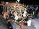 1994 Ford F-250 - This truck is in a state of disassembly, with its engine compartment exposed and parts scattered around.