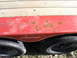 2005 Ford F-250 - Close-up of a red trailer fender showing rust damage and two wheels.