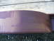 2005 Ford F-250 - A close-up view of a purple fender flare, showing brush strokes from recent painting. A tire is visible beneath the flare.