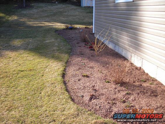 House siding, lawn, and gravel landscaping with a date stamp of 08-04-2009