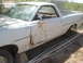 1973 Ford Ranchero - This 1973 Ford Ranchero shows significant rust and damage on its side, with the number '125' visible on the fender.