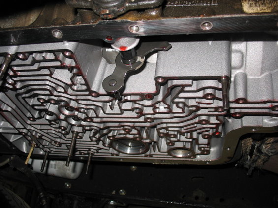Transmission pan with valve body and shift lever visible