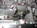1995 Ford C-350 (Centurion Conversions) - Close-up view of a transmission valve body, showing internal components and red fluid residue.