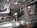 1995 Ford C-350 (Centurion Conversions) - Internal view of an automatic transmission, highlighting the shift linkage and metal casing with traces of transmission fluid.