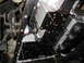 1995 Ford C-350 (Centurion Conversions) - Underside view of a vehicle's transmission pan and valve body, showing mechanical components and fluid.