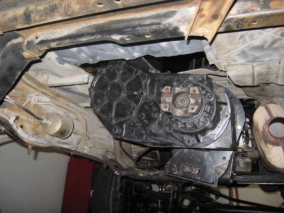 Underside view of a vehicle's transfer case and part of the exhaust system