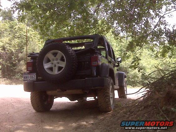 Black 2008 Jeep Wrangler rear view on a dirt road