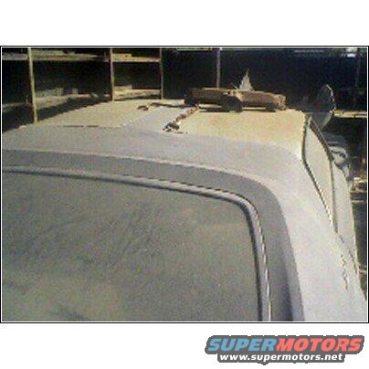 Gray car roof with a chain and two objects on top, seen from above