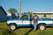 1985 Ford Ranger - A man stands next to a blue and white Ford Ranger pickup truck on a sunny day.