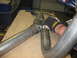 1979 Ford Bronco - A person welds exhaust pipes together in a workshop setting.