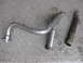 1979 Ford Bronco - Custom exhaust pipe and flex pipe components laid out on a concrete surface.