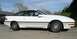 1989 Ford Probe - A white 1989 Ford Probe is parked outdoors, showing its side profile and red interior.