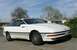 1989 Ford Probe - White 1989 Ford Probe coupe sits in a driveway under a partly cloudy sky.