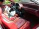 1989 Ford Probe - Interior view of a car with a man reading a newspaper while sitting in the driver's seat.