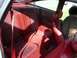1989 Ford Probe - Interior view of red velour rear seats and red leather front seats, with seatbelts visible.