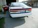 1989 Ford Probe - Rear view of a white 1989 Ford Probe with the driver's door open, parked in a driveway.