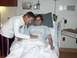 1997 Ford Probe - A man places his hand on his partner's pregnant belly while she smiles in a hospital room.