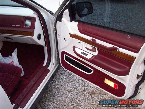 1992 Mercury Grand Marquis interior door panel with maroon and white trim, wood accents, and power window controls