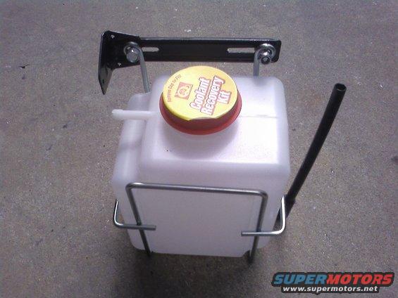 Coolant recovery tank with yellow cap labeled "Coolant Recovery Kit"