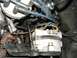1985 Ford Crown Victoria LTD - Close-up view of an engine's alternator and distributor cap with spark plug wires.