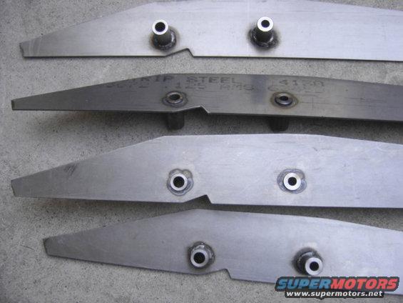 four metal brackets with holes and welds, one has text that says 'CRIP STEEL 125 RMS 4150'