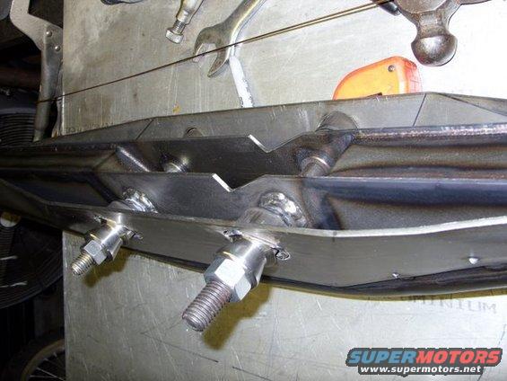 Custom metal fabrication with bolts and welds, viewed from below
