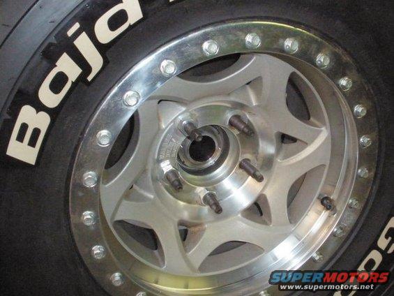 Close-up of a BFGoodrich Baja tire and a silver multi-spoke wheel with visible lug nuts