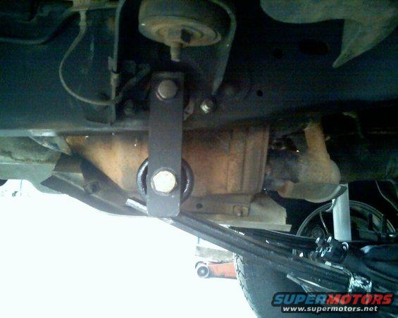 Close-up of vehicle undercarriage showing suspension and drivetrain components
