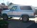 1982 Ford Bronco - Side view of a two-tone blue and white 1982 Ford Bronco parked outside.