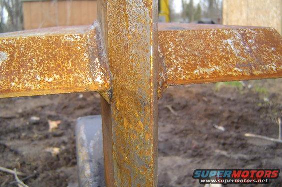 Rusted metal part with a cross shape
