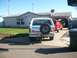 1982 Ford Bronco - Rear view of a 1982 Ford Bronco parked in a driveway with a red SUV nearby.