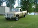 1975 International Scout II - This 1975 International pickup truck is parked on a grassy area next to a body of water.