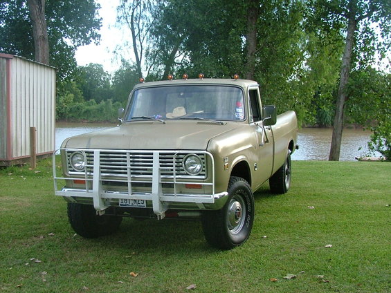 Tan 1975 International Scout II pickup truck, 3q-front view, with white grille guard