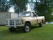 1975 International Scout II - This 1975 International Scout II pickup truck features a prominent white brush guard and is parked outdoors on a grassy area.