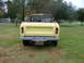 1975 International Scout II - Rear view of a yellow 1975 International Scout II convertible pickup truck parked on a grassy lawn.