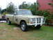 1975 International Scout II - This 1975 International Scout II pickup features a prominent white brush guard and is parked outdoors.