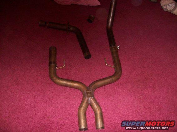 Exhaust system part against pink background