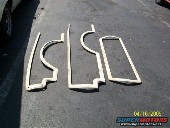 Four beige weatherstripping pieces laid out on asphalt